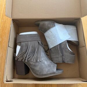 Grey fringe open toed heeled booties by Francesca’s